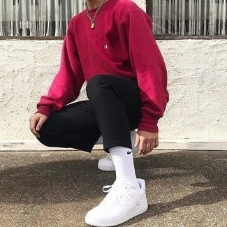 Hot Pink Sweatshirt Outfits For Men: This relaxed pairing of a hot pink sweatshirt and black chinos is super easy to pull together without a second thought, helping you look dapper and ready for anything without spending a ton of time digging through your wardrobe. Add white leather low top sneakers to the equation to tie the whole outfit together.
