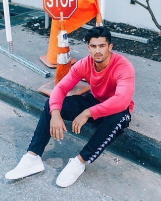 Pink Sweatshirt Outfits For Men: A pink sweatshirt and navy sweatpants are awesome menswear must-haves to integrate into your off-duty styling rotation. White canvas slip-on sneakers are a surefire way to breathe a touch of refinement into your outfit.