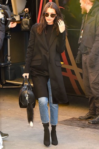 Bella Hadid wearing Black Elastic Ankle Boots, Blue Embellished Jeans, Black Crew-neck Sweater, Black Coat