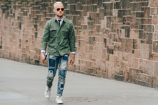 Men's White Low Top Sneakers, Blue Ripped Jeans, Light Blue Dress Shirt, Dark Green Military Jacket