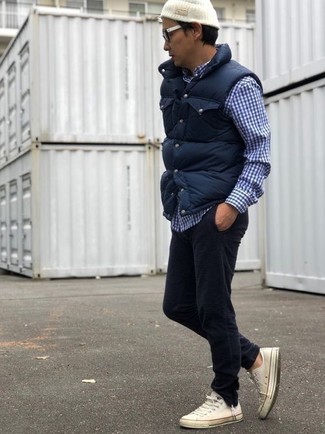 Men's White Canvas Low Top Sneakers, Black Corduroy Jeans, Navy and White Gingham Long Sleeve Shirt, Navy Quilted Gilet