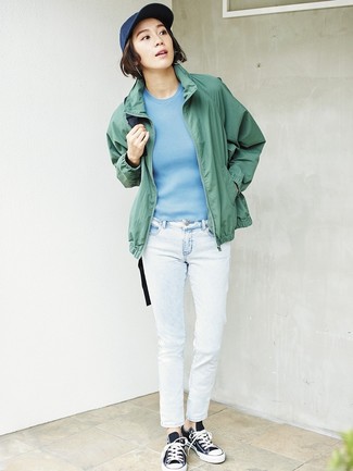 Women's Black and White Canvas Low Top Sneakers, White Jeans, Light Blue Short Sleeve Sweater, Green Windbreaker