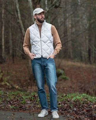 Men's White Canvas Low Top Sneakers, Blue Jeans, Tan Wool Turtleneck, White Quilted Gilet