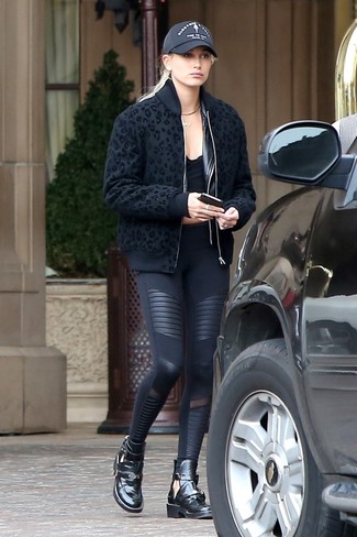 Hailey Baldwin wearing Black Chunky Leather Ankle Boots, Black Leggings, Black Cropped Top, Black Leopard Bomber Jacket