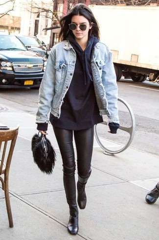 Kendall Jenner wearing Black Leather Mid-Calf Boots, Black Leather Leggings, Black Hoodie, Light Blue Denim Jacket