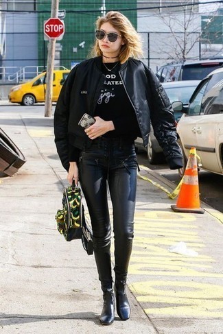 Gigi Hadid wearing Black Leather Ankle Boots, Black Leather Leggings, Black and White Print Sweatshirt, Black Bomber Jacket