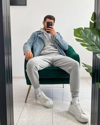 Light Blue Biker Jacket Outfits For Men: For something more on the casual end, try this combo of a light blue biker jacket and a grey track suit. To bring some extra flair to your ensemble, introduce white leather low top sneakers to your getup.