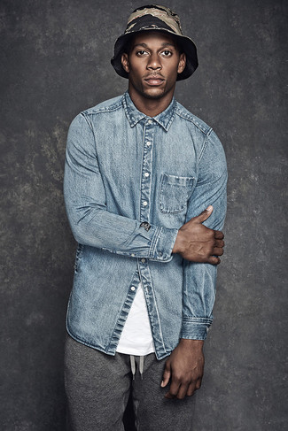 Wear a light blue denim shirt and grey sweatpants for a laid-back menswear style with a bold spin.