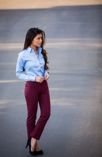 This is definitive proof that a light blue dress shirt and burgundy skinny pants look amazing when paired up. A pair of black suede pumps fits right in here.