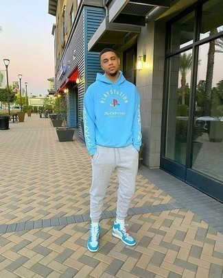 Light Blue Hoodie Outfits For Men: Wear a light blue hoodie with grey sweatpants for a casual ensemble with an edgy twist. Complement this look with white and blue leather high top sneakers and the whole outfit will come together wonderfully.