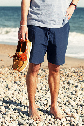 Light Blue V-neck T-shirt Outfits For Men: This modern casual combination of a light blue v-neck t-shirt and navy shorts is extremely easy to put together without a second thought, helping you look stylish and ready for anything without spending a ton of time rummaging through your closet. Introduce a pair of orange leather boat shoes to the mix to mix things up.