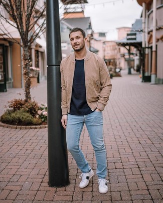 Men's White Low Top Sneakers, Light Blue Jeans, Navy Crew-neck Sweater, Tan Suede Bomber Jacket