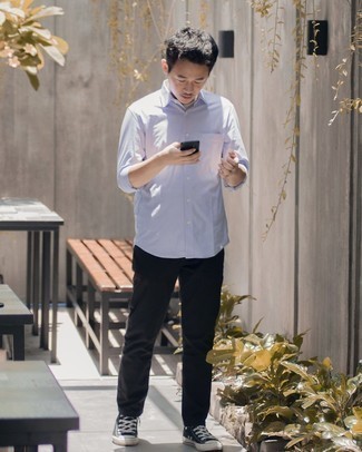 Black and White Canvas Low Top Sneakers Outfits For Men: A light blue long sleeve shirt and black chinos? This is easily a wearable ensemble that anyone can rock on a daily basis. A pair of black and white canvas low top sneakers easily revs up the style factor of this outfit.