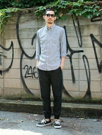 Men's Light Blue Long Sleeve Shirt, Dark Green Chinos, Black and White Canvas Low Top Sneakers, Dark Brown Sunglasses