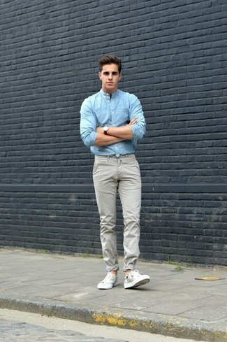 White and Black Print Canvas Low Top Sneakers Outfits For Men: This combination of a light blue chambray long sleeve shirt and grey chinos is a safe go-to for an effortlessly stylish getup. Inject a dose of stylish casualness into this look by rounding off with white and black print canvas low top sneakers.