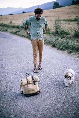 Beige Canvas Backpack Outfits For Men: To achieve a casual ensemble with a contemporary spin, you can easily rock a light blue chambray long sleeve shirt and a beige canvas backpack. Want to play it down on the shoe front? Complement this outfit with a pair of dark brown suede sandals for the day.
