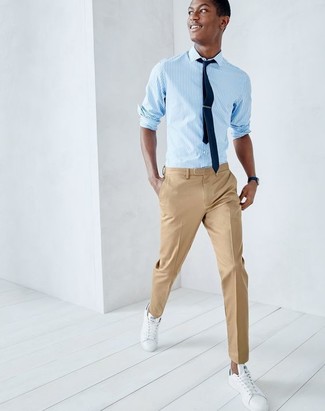 Light Blue Vertical Striped Long Sleeve Shirt Outfits For Men: A light blue vertical striped long sleeve shirt and khaki dress pants are among the key elements of a solid wardrobe. You know how to add a more laid-back vibe to this look: white leather low top sneakers.