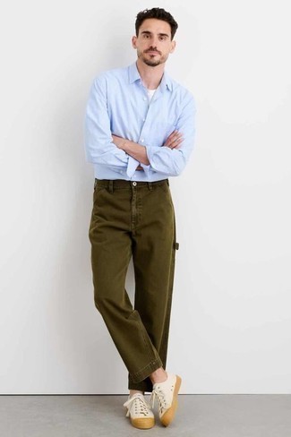 Olive Chinos Outfits: A light blue long sleeve shirt and olive chinos are stylish menswear pieces, without which our closets would certainly feel incomplete. For something more on the cool and laid-back side to complete your outfit, introduce a pair of beige canvas low top sneakers to the mix.