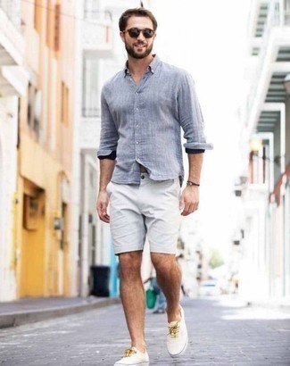 Light Blue Chambray Long Sleeve Shirt with White Shorts Outfits For Men: This laid-back pairing of a light blue chambray long sleeve shirt and white shorts is a life saver when you need to look good in a flash. White canvas low top sneakers integrate effortlessly within a myriad of outfits.