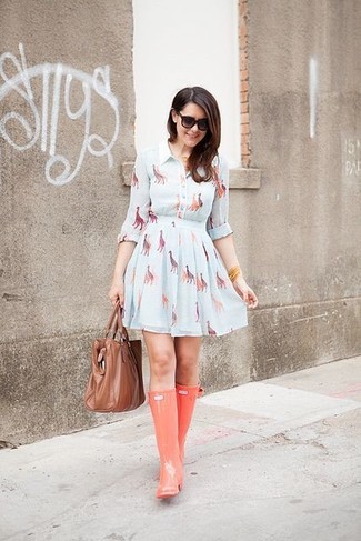 Consider wearing a light blue print skater dress for a relaxed look with a modern take. If you wish to easily dial down this look with shoes, introduce a pair of orange rain boots to the equation.