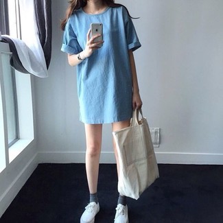 Tan Canvas Tote Bag Outfits: Go for a light blue denim shift dress and a tan canvas tote bag and you'll be prepared for wherever this day takes you. Let your outfit coordination skills really shine by rounding off your look with white plimsolls.