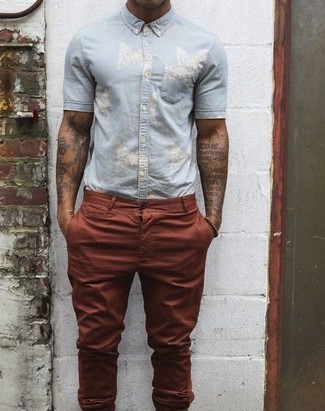 Burgundy Chinos Summer Outfits: A light blue short sleeve shirt looks so great when paired with burgundy chinos. There are a multitude of ways to look cool and survive the baking hot weather, and that's one of them.