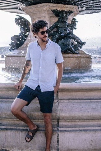 Grey Leather Sandals Outfits For Men: A light blue short sleeve shirt and navy shorts are among the crucial items in any gent's great off-duty collection. You could perhaps get a bit experimental when it comes to shoes and complete this ensemble with grey leather sandals.