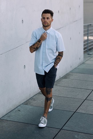 Grey Canvas Low Top Sneakers Outfits For Men: Fashionable and practical, this relaxed casual pairing of a light blue short sleeve shirt and navy shorts brings variety. Add grey canvas low top sneakers to the mix and off you go looking awesome.