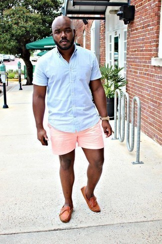 Hot Pink Shorts Outfits For Men: This combination of a light blue short sleeve shirt and hot pink shorts is on the casual side but is also seriously stylish and truly stylish. Let your outfit coordination credentials really shine by finishing your ensemble with tobacco leather driving shoes.
