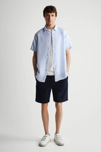 White Canvas Low Top Sneakers Outfits For Men: This casual combo of a light blue short sleeve shirt and navy shorts is a safe option when you need to look cool and casual but have no extra time. When it comes to shoes, this look is complemented nicely with white canvas low top sneakers.