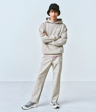 Light Violet Crew-neck T-shirt Outfits For Men: Demonstrate your expertise in menswear styling by opting for this casual combination of a light violet crew-neck t-shirt and a beige track suit. A pair of grey athletic shoes is a fail-safe footwear style here that's full of personality.
