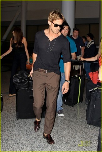 Gosling wearing Black Long Sleeve Henley Brown Dress Pants, Dark Brown Leather Loafers, Brown Leather Belt | Lookastic