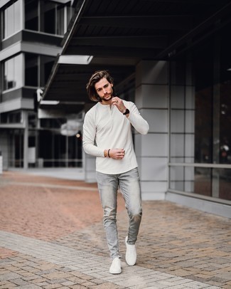 White Long Sleeve Henley Shirt Outfits For Men: Try pairing a white long sleeve henley shirt with grey jeans for a no-nonsense look that's also pieced together nicely. White canvas low top sneakers work spectacularly well within this outfit.