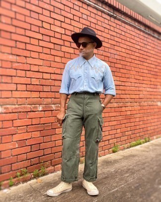 Black Hat Outfits For Men: Pairing a light blue embroidered chambray long sleeve shirt with a black hat is a wonderful option for a casually cool ensemble. Go the extra mile and switch up your ensemble by sporting beige canvas high top sneakers.