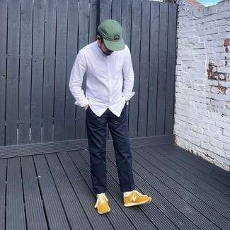 Navy Chinos Outfits: Opt for a white long sleeve shirt and navy chinos to pull together a casually cool look. With shoes, follow the casual route with a pair of mustard athletic shoes.