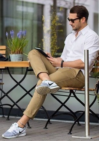 White and Blue Athletic Shoes Outfits For Men: The combo of a white long sleeve shirt and khaki chinos makes for a solid laid-back outfit. When this ensemble looks too fancy, dress it down by finishing off with a pair of white and blue athletic shoes.