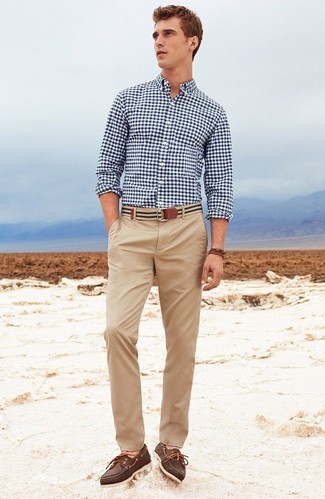 Tan Canvas Belt Outfits For Men: A navy and white gingham long sleeve shirt and a tan canvas belt are absolute essentials if you're figuring out a casual wardrobe that matches up to the highest sartorial standards. Clueless about how to complete this getup? Rock a pair of dark brown leather boat shoes to boost the wow factor.