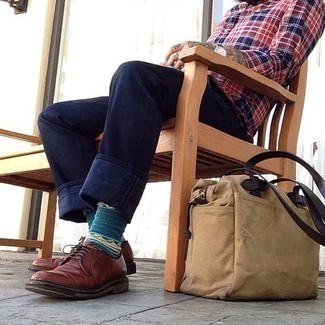 Tan Canvas Tote Bag Outfits For Men: Reach for a red and navy plaid long sleeve shirt and a tan canvas tote bag for a fashionable and easy-going look. And if you want to easily rev up your look with one single piece, why not complement your outfit with brown leather derby shoes?
