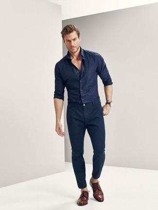 Brown Leather Derby Shoes Smart Casual Outfits: Parade your expertise in men's fashion by opting for this casual combo of a navy long sleeve shirt and navy chinos. You could perhaps get a little creative with footwear and spruce up this outfit with a pair of brown leather derby shoes.