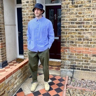 Navy Bucket Hat Outfits For Men: A light blue vertical striped long sleeve shirt and a navy bucket hat are a wonderful look to add to your casual collection. For something more on the sophisticated side to round off your ensemble, complete your ensemble with a pair of beige suede desert boots.