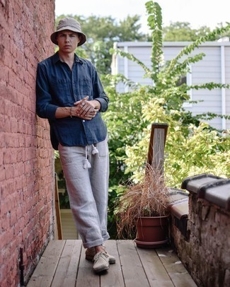 Grey Bucket Hat Outfits For Men: We're all seeking functionality when it comes to fashion, and this contemporary combo of a navy long sleeve shirt and a grey bucket hat is a vivid example of that. If you feel like dressing up a bit, complete your ensemble with a pair of beige suede desert boots.