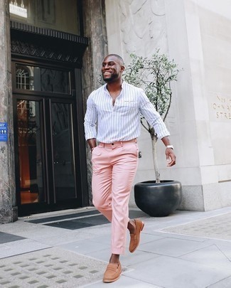 White Vertical Striped Long Sleeve Shirt Outfits For Men: A white vertical striped long sleeve shirt and pink chinos combined together are a perfect match. And if you want to easily class up your ensemble with a pair of shoes, add a pair of tan suede loafers to the equation.