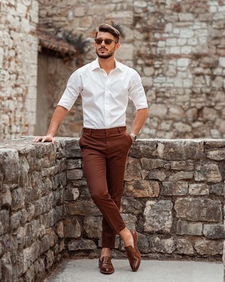 Brown Leather Loafers Summer Outfits For Men: The versatility of a white long sleeve shirt and brown chinos guarantees they will always be on regular rotation. Add brown leather loafers to the equation for an extra dose of class. There are a variety of ways to look neat and live through the super hot weather, and this here is one of them.