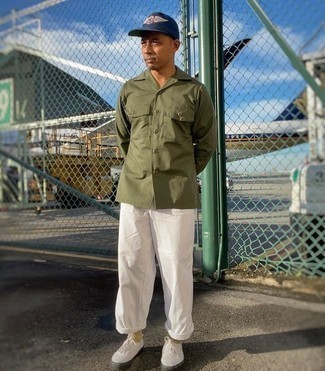 Navy Print Baseball Cap Outfits For Men: An olive long sleeve shirt and a navy print baseball cap are a nice pairing to have in your daily off-duty repertoire. White canvas low top sneakers are an effortless way to give an air of sophistication to this look.