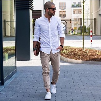 Tobacco Leather Zip Pouch Outfits For Men: If you like practical menswear, marry a white long sleeve shirt with a tobacco leather zip pouch. Finishing with a pair of white low top sneakers is a fail-safe way to inject an added dose of polish into this outfit.