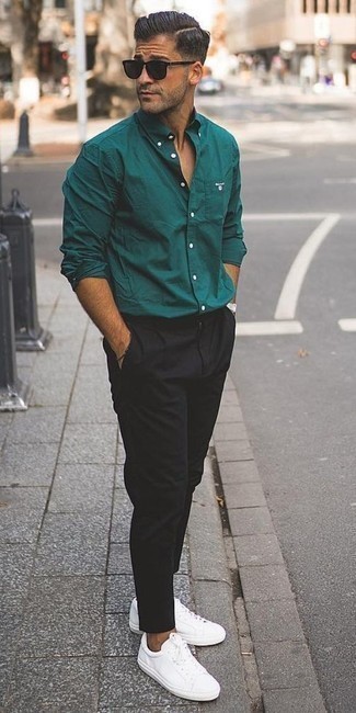 Dark Green Long Sleeve Shirt Outfits For Men: Consider pairing a dark green long sleeve shirt with black chinos for a casual and cool and fashionable outfit. A nice pair of white leather low top sneakers is the simplest way to give a touch of stylish casualness to this outfit.