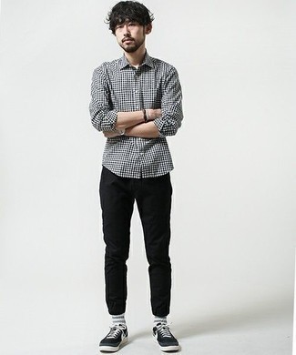 White and Navy Gingham Long Sleeve Shirt Outfits For Men: Pair a white and navy gingham long sleeve shirt with black chinos to assemble an interesting and modern-looking laid-back outfit. Introduce black and white canvas low top sneakers to your outfit and the whole ensemble will come together.