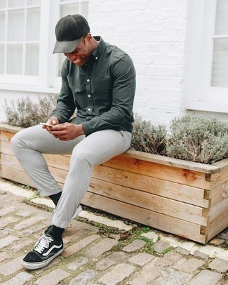 Olive Baseball Cap Outfits For Men: This edgy pairing of a dark green long sleeve shirt and an olive baseball cap is capable of taking on different moods depending on how you style it. Black and white canvas low top sneakers will give a dose of refinement to an otherwise mostly casual look.