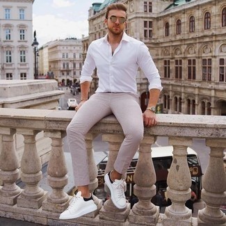Gold Sunglasses Outfits For Men: To assemble an off-duty getup with a fashionable spin, dress in a white long sleeve shirt and gold sunglasses. Let your styling expertise truly shine by finishing this ensemble with a pair of white and black leather low top sneakers.