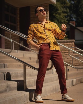 Brown Chinos Summer Outfits: This on-trend look is easy to break down: a tobacco print long sleeve shirt and brown chinos. Look at how nice this outfit goes with white and navy canvas low top sneakers. What better pick for a super hot summer afternoon?